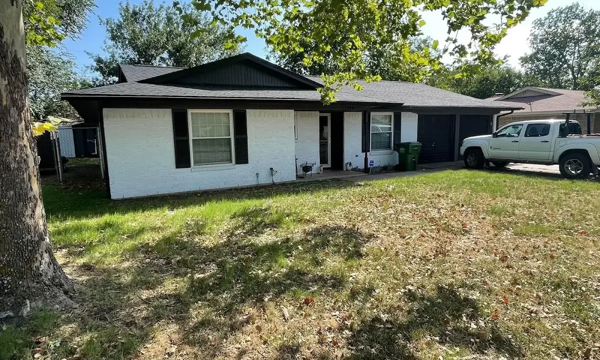 Professional roofing crew working on a residential roof in Magna